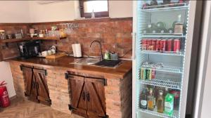 a kitchen with a refrigerator with its door open at Kuća za odmor Vista in Slavonski Brod