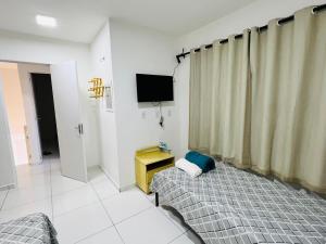 a bedroom with a bed and a television in it at Casa duplex em condomínio Parnaiba in Parnaíba +9 photos