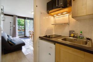 a kitchen with a sink and a counter top at Au pied des pistes (Le Corbier/73) in Villarembert