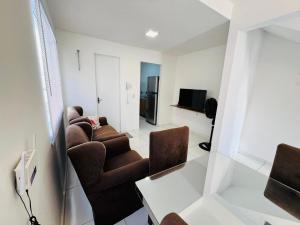 a living room with two chairs and a television at Casa duplex em condomínio Parnaiba in Parnaíba