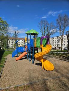 a playground with colorful slides in a park at AchiDav 135 in Onești