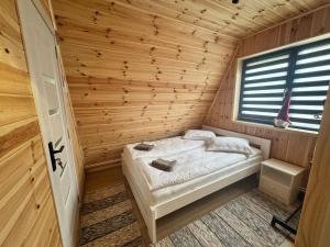 a bedroom with a bed in a wooden room at 3A-Chalet-Liban in Liban