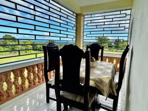 a table with two chairs in front of a window at Apartamentos-Oliver in Las Galeras