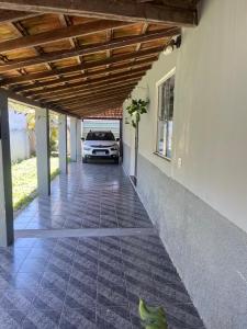a car parked in a garage with a car parked at Casa de Temporada, 2 Quartos com Ar - Prado BA in Prado +2 photos