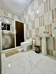a bathroom with a toilet and a sink at Apartamentos-Oliver in Las Galeras +21 photos