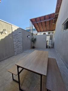 a wooden table sitting on top of a patio at loft climatizado próximo à Aperam in Timóteo