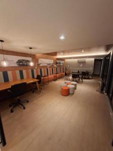 a large room with desks and chairs and tables at Vista Mar Icaraí Ingá in Niterói +53 photos