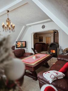 a living room with a table and a fireplace at Home Belić Golija in Radaljica