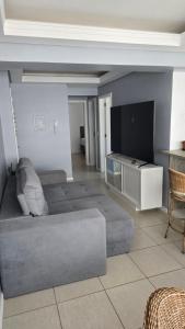 a living room with a couch and a table at Dona Iva in Capão da Canoa