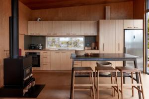 a kitchen with a table and chairs and a stove at Swansong - Experience simple environmental living in St Helens