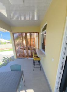 a small porch with a table and chairs on a balcony at AK Lodge Raiatea in Raiatea