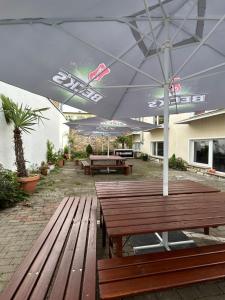 a patio with wooden benches and an umbrella at City Lux Hannover in Hannover +1 photo