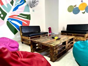 een woonkamer met 2 stoelen en een houten tafel bij Los Nonos Hostel in Guadalupe
