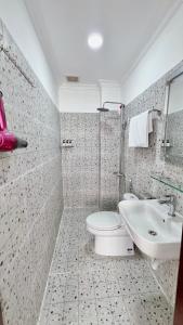 a bathroom with a toilet and a sink at Mật Ong HOUSE in Hue