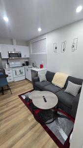 a living room with a couch and a table at Elian's Nest in Saskatoon