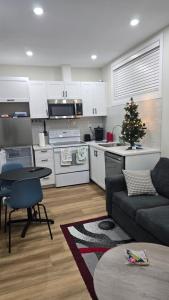 a kitchen and living room with a christmas tree in it at Elian's Nest in Saskatoon +43 photos