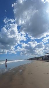 a person is standing on the beach at Cabaña 4 in Necochea