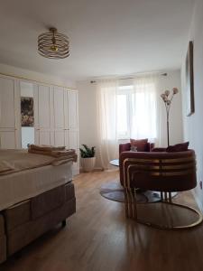 a living room with a bed and a couch at Paulla in Šibenik
