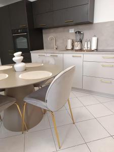 a kitchen with a table and chairs in it at Paulla in Šibenik +12 photos