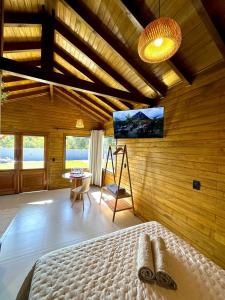 a bedroom with a bed in a wooden wall at Cabana Raiz & Mar - 01 in Imbituba