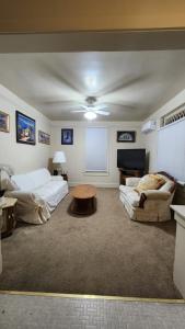 a living room with a bed and a couch and a table at Historic Reno Home in Reno