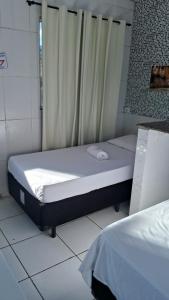 En eller flere senge i et værelse på Pousada Serra Azul