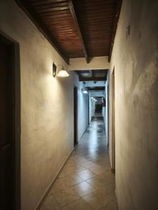 an empty hallway with a light on the wall at Hostería Michel in Villa Gesell +3 photos
