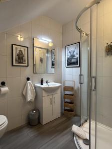 a bathroom with a sink and a shower at Shangri-La Large Family Townhouse free carpark in Killarney