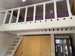 an empty bunk bed in a room with cabinets at Condo Riviera in Puerto Aventuras