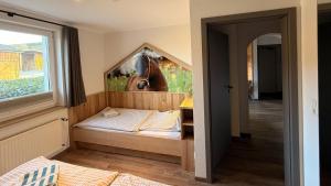 a bedroom with a bed with a horse picture on the wall at Hardthof-Sauerland in Schmallenberg +53 photos