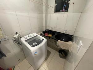 a small bathroom with a toilet and a sink at Ap Seabra 2 quartos in Seabra