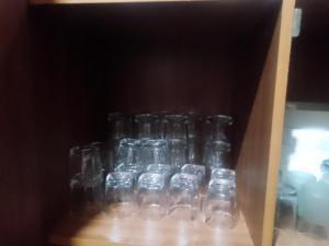 a group of glass bottles sitting on a shelf at Sehandi Hotel - Arachchi Gedara in Ella