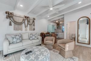 a living room with a couch and two chairs at Anchor Inn & Cottages in Sanibel +62 photos
