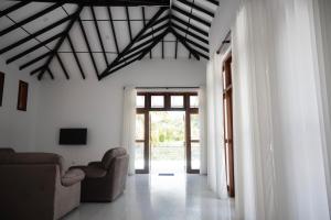 a living room with a couch and a ceiling at Ashasha Villa in Negombo