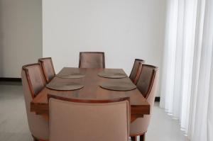 a dining room table with chairs and a wooden table at Ashasha Villa in Negombo +9 photos