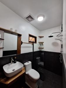 a bathroom with a white toilet and a sink at Tulog 1 in El Nido +24 photos