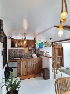 a kitchen with wooden cabinets and a counter top at Tulog 1 in El Nido