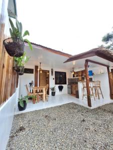 a kitchen and dining area of a house with plants at Tulog 1 in El Nido