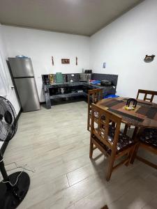 a kitchen with a refrigerator and a table in it at En-suite Paraiso #1 in Parrita
