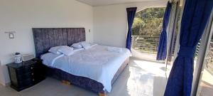 a bedroom with a large bed and a window at Supernova Glamping in Macanal