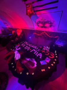 a room with a bed with purple and pink lighting at Rubino Private SPA & Room in Corato