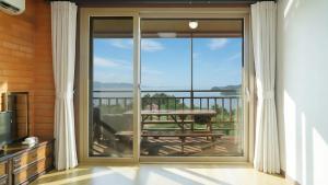 a sliding glass door with a view of a patio at Yeosu Hwangto Pension in Yeosu +2 photos