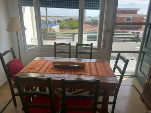 a wooden table with chairs and a plate on top at Irape in La Paloma