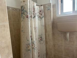 a bathroom with a shower curtain and a sink at Irape in La Paloma +27 photos