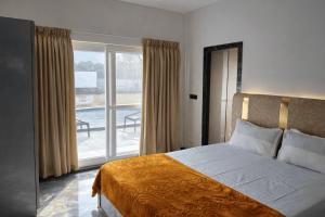 a bedroom with a bed and a view of a pool at Horizon vue Villas in Rājahmundry