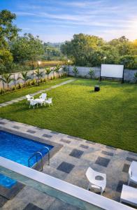 a backyard with a pool and a basketball hoop at Horizon vue Villas in Rājahmundry
