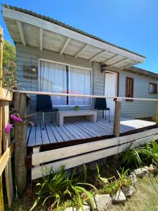 a wooden deck in front of a house at TINY HOUSE Refugio de Mar in Mar del Plata +5 photos