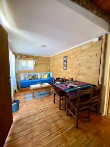 a living room with a table and a blue couch at TINY HOUSE Refugio de Mar in Mar del Plata