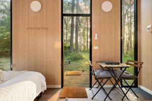 a bedroom with a bed and a desk with a table at Quantum Field by Tiny Away in Toolangi +7 photos