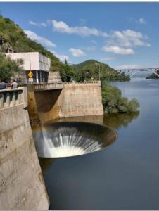 a bridge over a river with a waterfall at El Tito Alojamiento in San Roque +5 photos